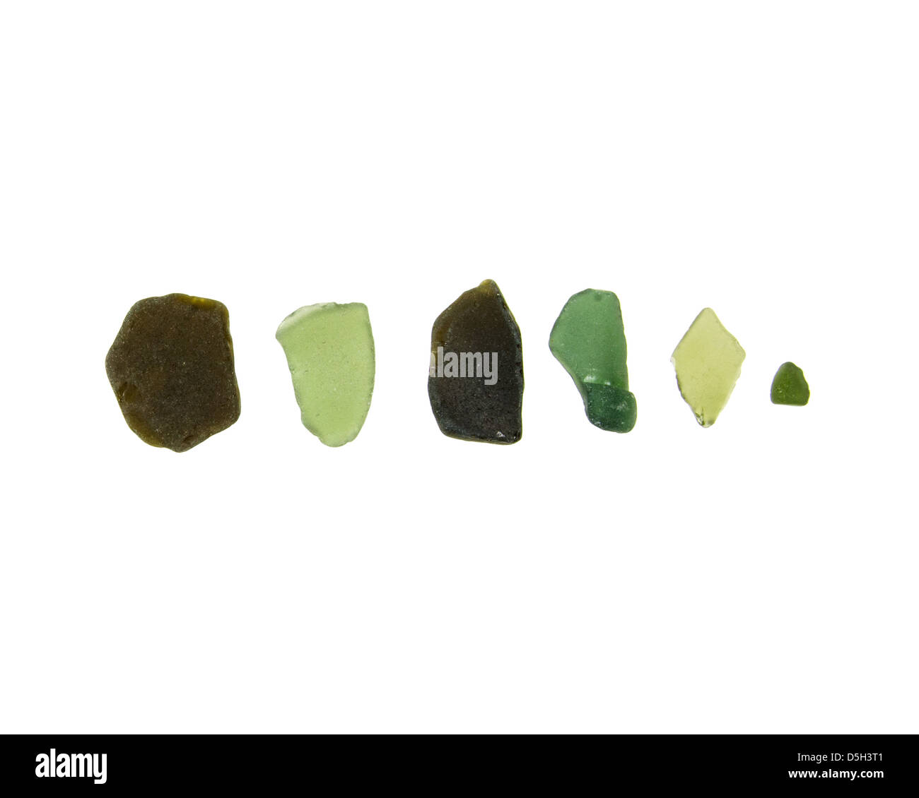 Six pieces of bright green and dark green sea glass found on the coast of Maine. Stock Photo