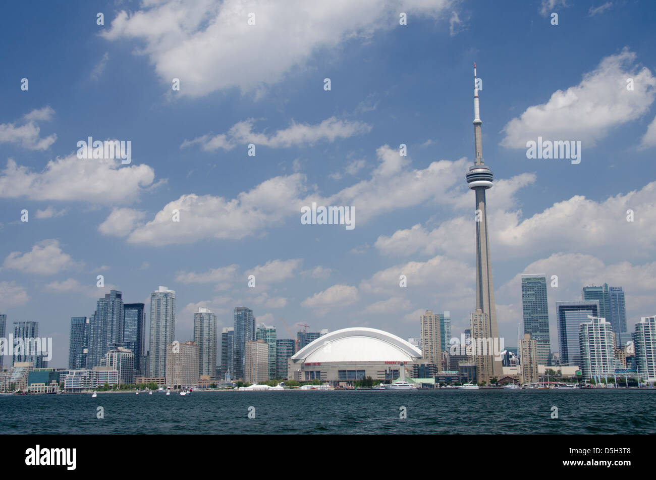 Canada, Ontario, Toronto. Lake Ontario city skyline view of the iconic CN Tower and the Rogers Centre from scenic harbor cruise. Stock Photo