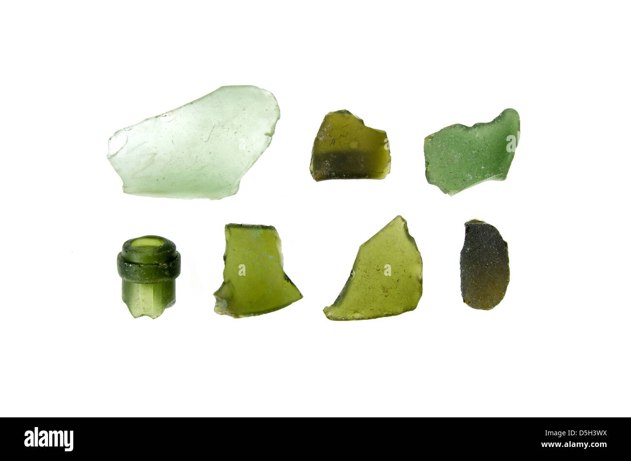 Seven pieces of weathered green sea glass found on the coast of Maine. Stock Photo