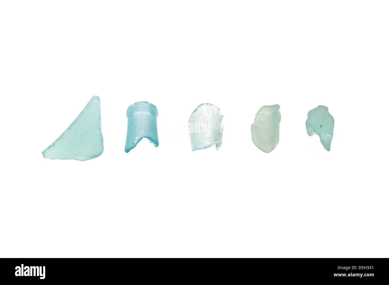 Five pieces of aqua beach glass on a white background. Stock Photo