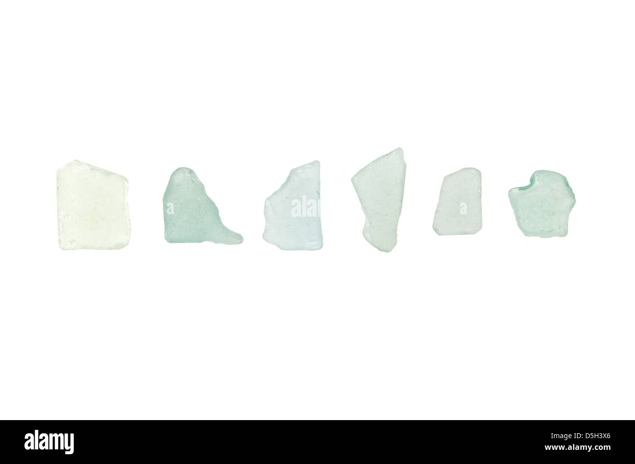 Six pieces of pastel turquoise sea glass found on the beach in Maine. Stock Photo