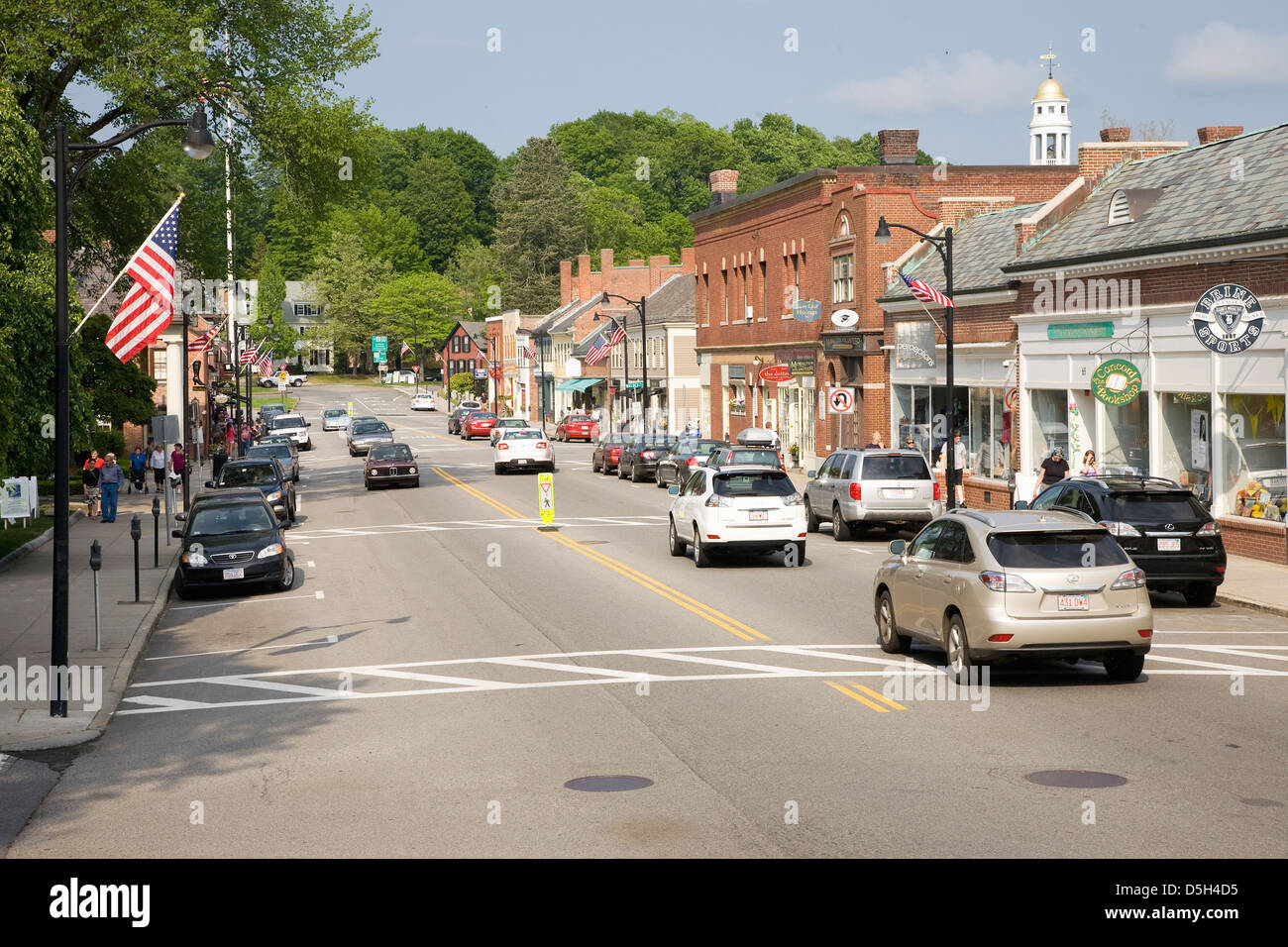 Storefronts in historic Concord, MA on Memorial Day Weekend with American Flags displayed Stock Photo