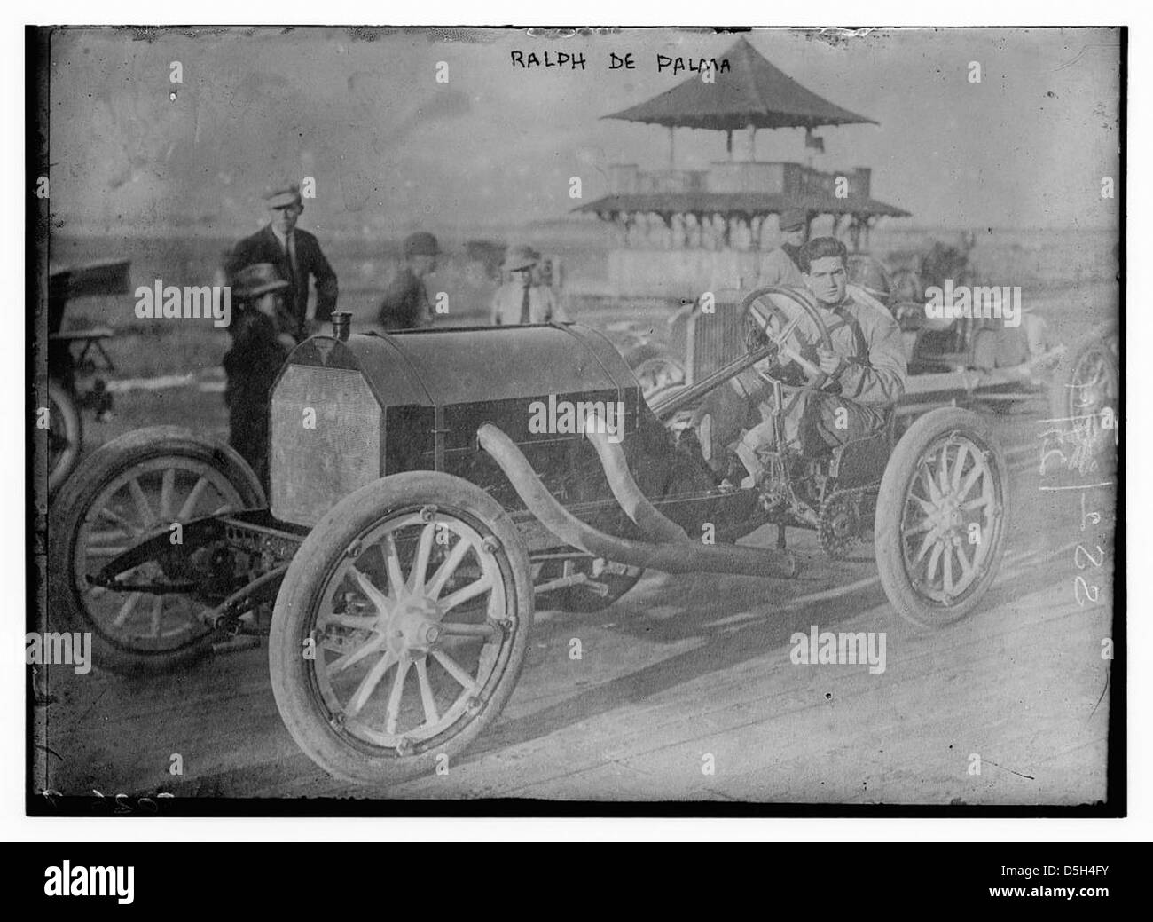 Ralph de Palma, a famous auto racer, is shown with his Mercedes race car at the Vanderbilt Cup Race in Santa Monica, California, on February 26, 1914. The event showcases early 20th-century automobile racing and De Palma's contribution to the sport. Stock Photo