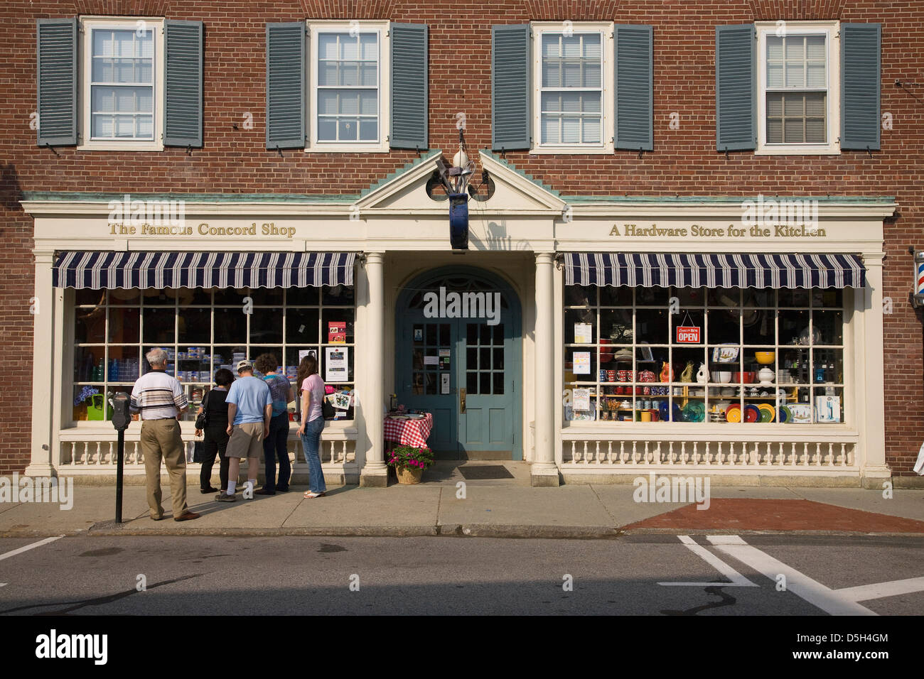 Tourists look into window of The Famous Concord Shop in historic Concor, MA outside of Boston on Memorial Day, 2011 Stock Photo