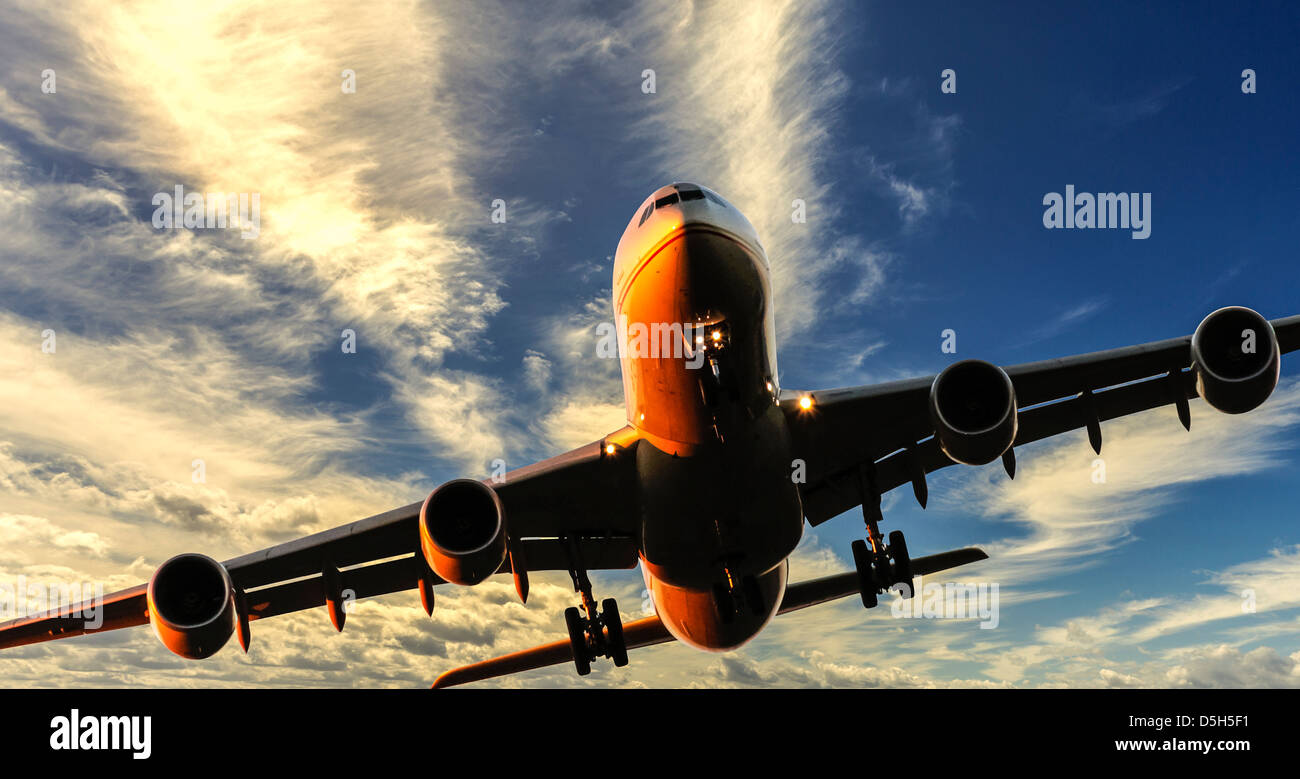 Aircraft landing set against bright sky at sunset. Composite Image Stock Photo