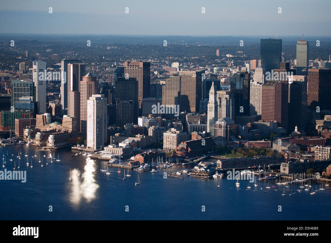 AERIAL VIEW of Wind Turbine and Tug Boat pushing red barge, Boston Harbor, MA Stock Photo