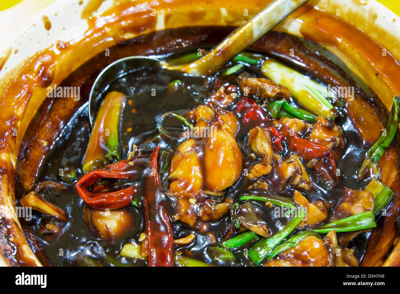 Claypot Frog Legs with Green Spring Onions in Brown Sauce Chinese Dish Closeup Stock Photo