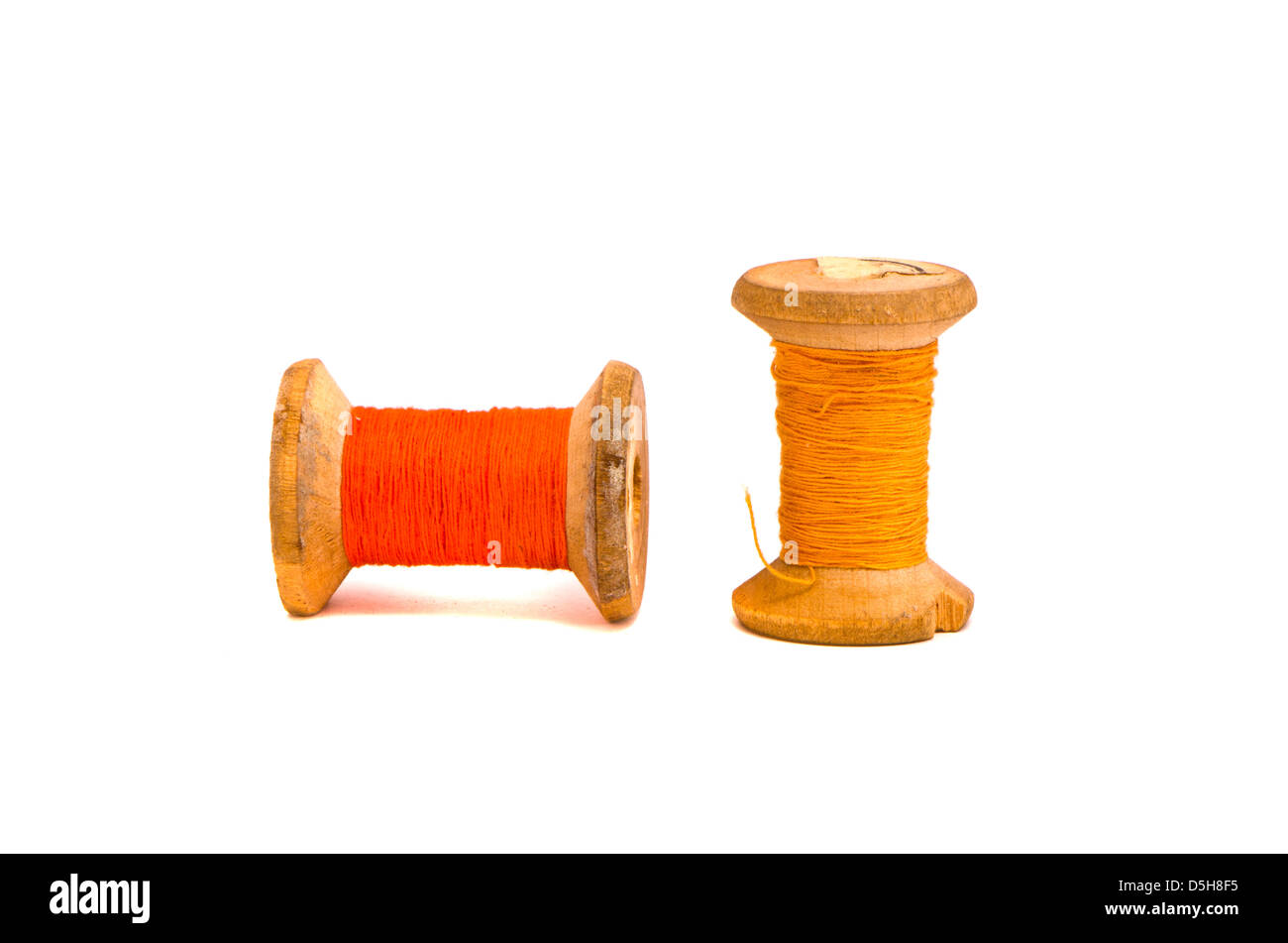 old grunge two wooden  thread spools isolated on white Stock Photo