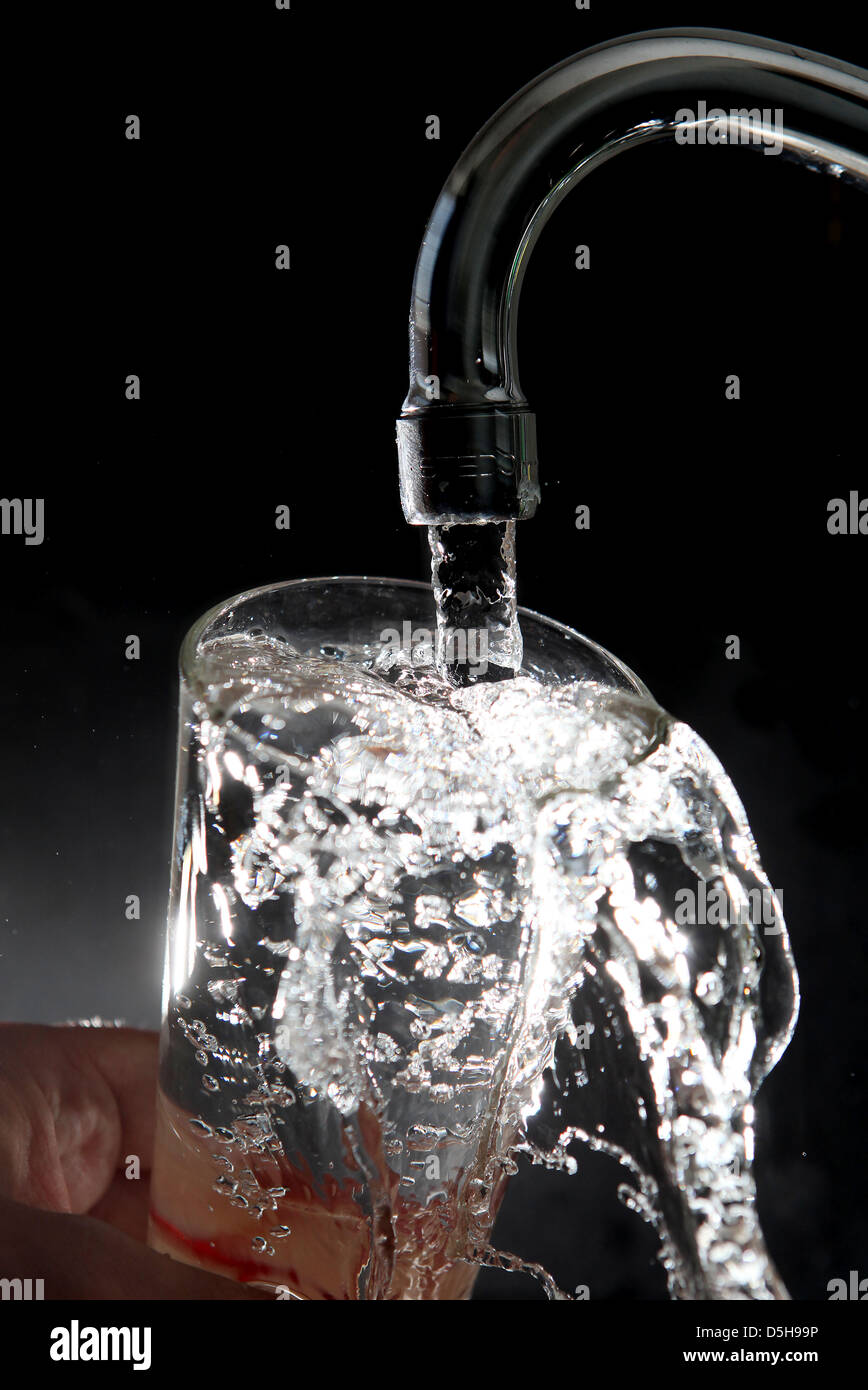 File Drinking Water Runs Out Of A Faucet Into A Glass In Cologne
