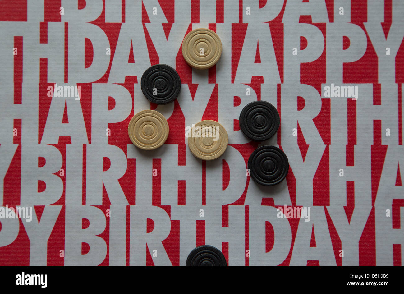 A shot of some 'happy birthday' wrapping paper in contrasting red and white colors Stock Photo