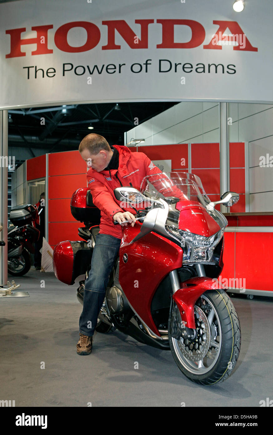 A trade fair stand staff member arranges the Honda VFR 1200 F for the  upcoming Motocycle Fair in Leipzig, Germany, 04 February 2010. A total of  220 exhibitors showcase their latest products
