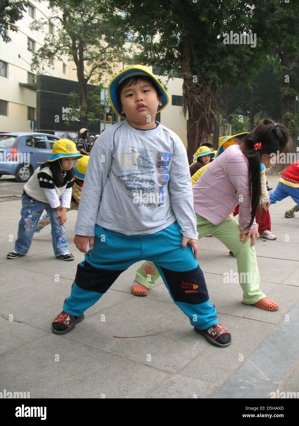 Fouryearold boys and girls on their way to gymnastics in a park in Hanoi, Vietnam, 07 December