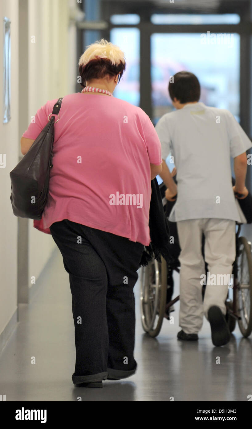 26-year-old woman Nicole (L) walks after her examination of a nutrition consultation at the clinic for internal medicine of University Leipzig, Germany, dated 17 January 2010. The young woman, who weighed 230 kg before a gastric surgery, is happy about her now 162 kg and wants to achieve the weight of 80 kg. She belongs to a group of patients who suffer of adiposity (obesity), whic Stock Photo