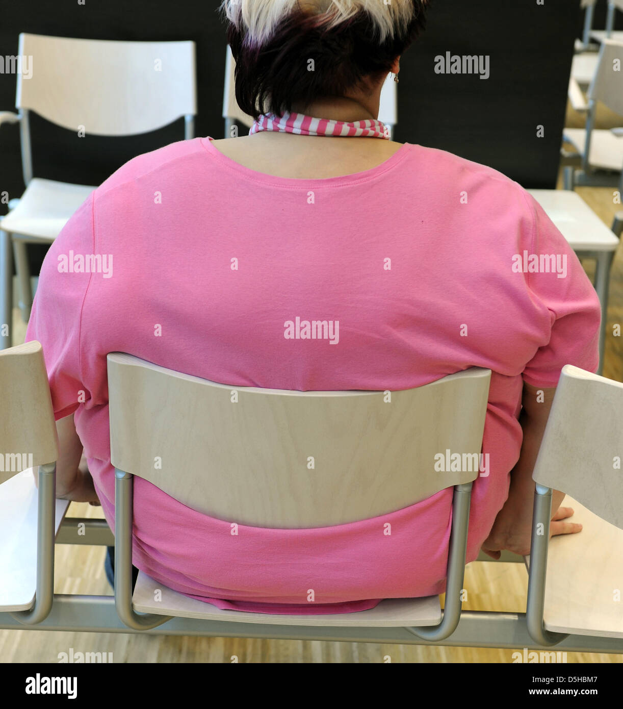 26-year-old woman Nicole sits on a chair previous to her examination of a nutrition consultation at the clinic for internal medicine of University Leipzig, Germany, dated 17 January 2010. The young woman, who weighed 230 kg before a gastric surgery, is happy about her now 162 kg and wants to achieve the weight of 80 kg. She belongs to a group of patients who suffer of adiposity (ob Stock Photo