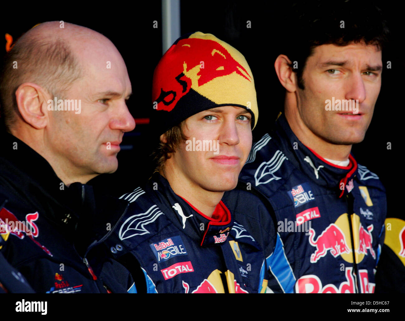 German Formula One driver Sebastian Vettel (C) of Red Bull, his teammate, Australian driver Mark Webber (R), and technical director and head designer Adrian Newey present the new Red Bull Racing race car RB6 in Jerez de la Frontera, Spain, 10 February 2010. Vice world champion Vettel will test the RB6 for the first time on 12 February 2010. The Formula One 2010 season will start on Stock Photo