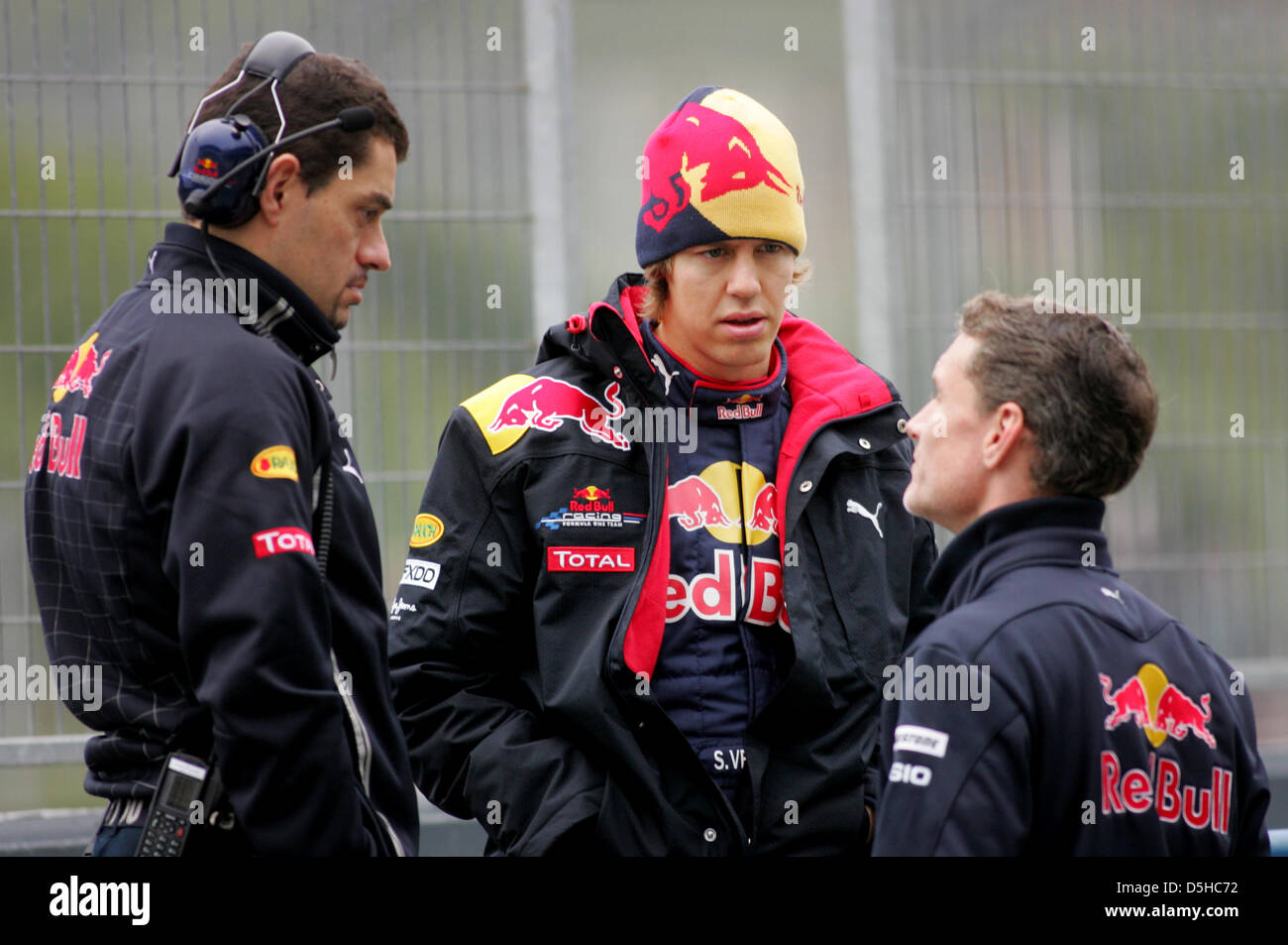 German Formula One driver Sebastian Vettel of Red Bull (C) talks to race engineer Guillaume Rocquelin (L) and former Formula One driver David Coulthard after the presentation of the new Red Bull Racing race car RB6 in Jerez de la Frontera, Spain, 10 February 2010. Vice world champion Vettel will test the RB6 for the first time on 12 February 2010. The Formula One 2010 season will s Stock Photo