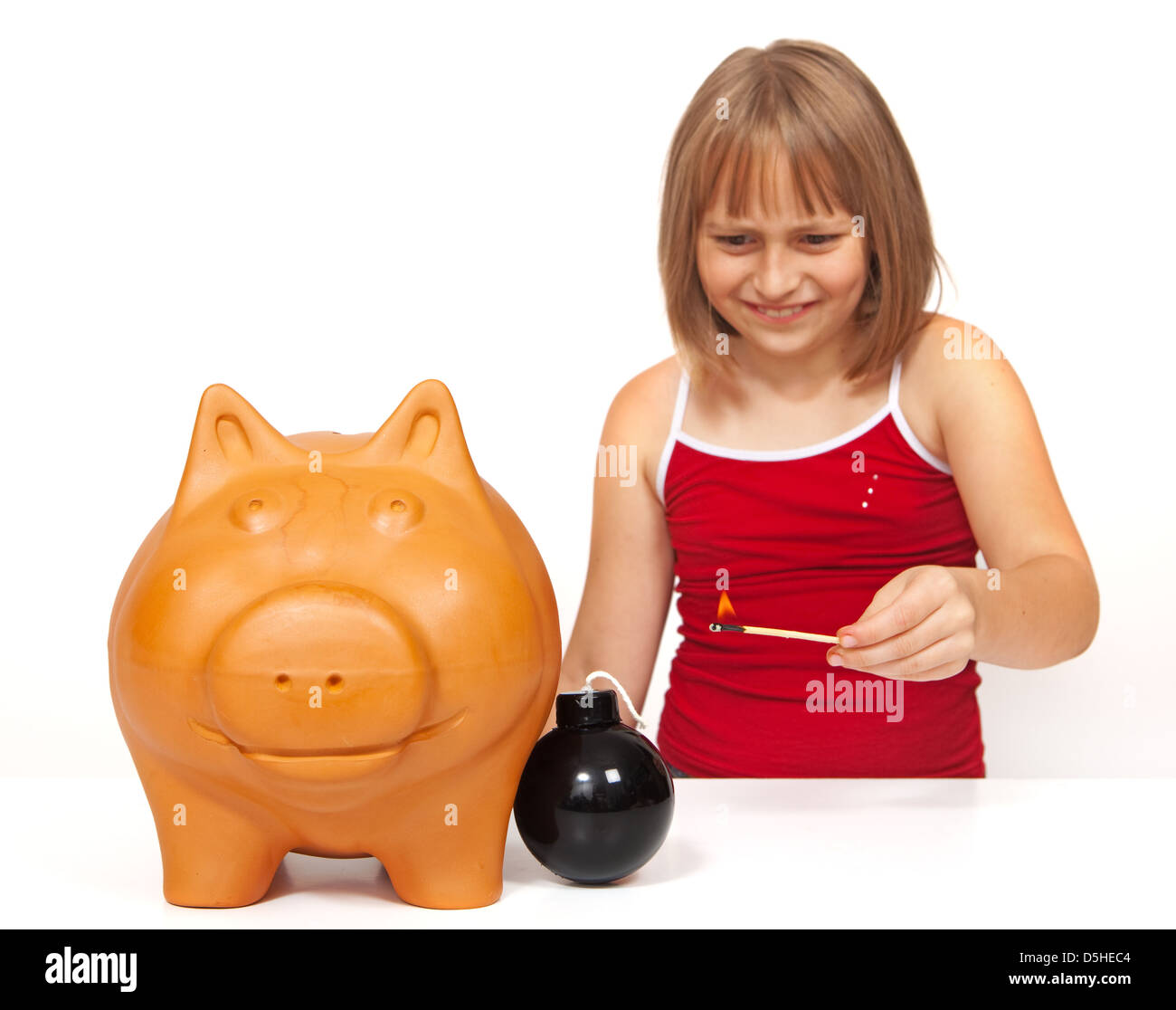 Little girl lighting a bomb to explode the piggy bank Stock Photo