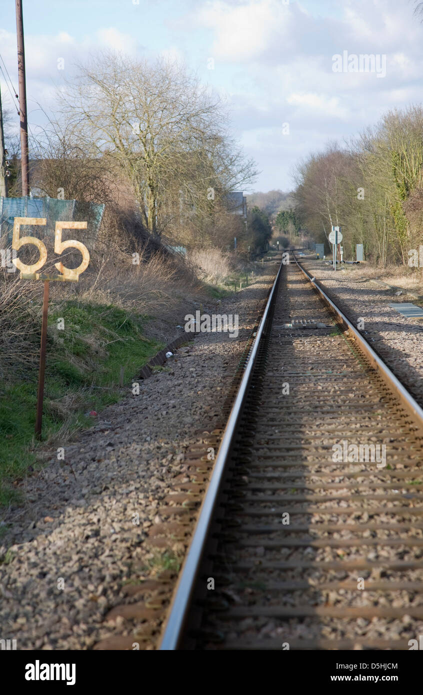 Railway sign meaning beginning of speed limit stretch at railroad  embankment with rail track disappearing in mist in background Stock Photo -  Alamy
