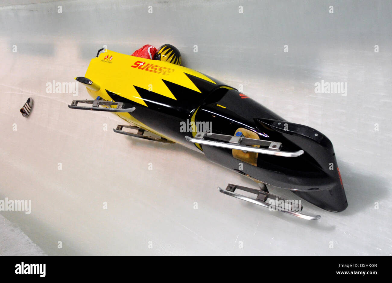 A shoe follows the Bob of Swiss 1 with Beat Hefti after his crash in a curve during Bobsleigh two-man training at the Whistler Sliding Center during the Vancouver 2010 Olympic Games in Whistler, Canada, 17 February 2010. Stock Photo