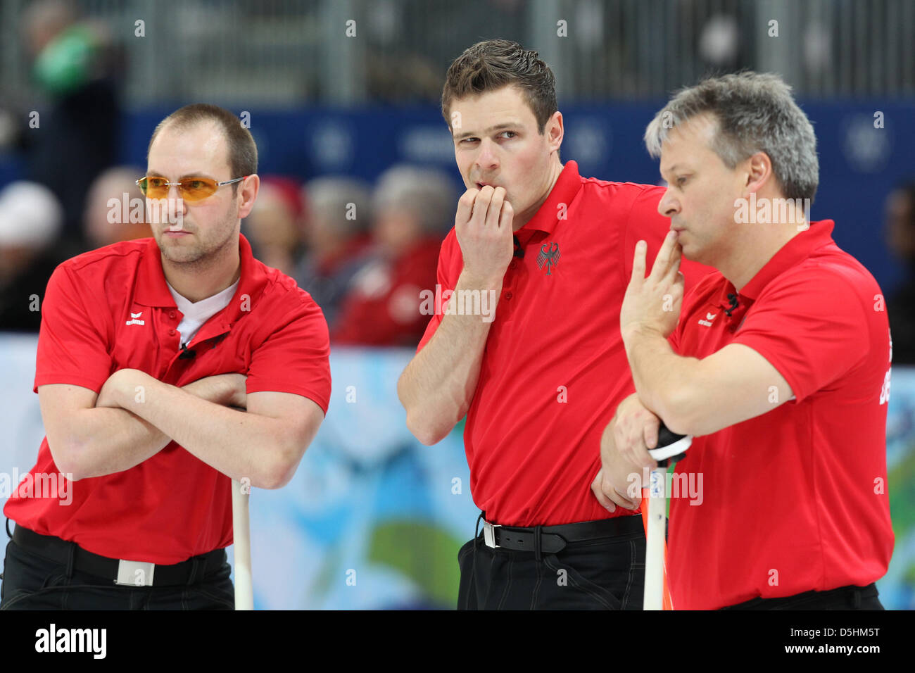 Andreas Kempf (R-L), Andy Lang and Holger Hoehne of team Germany talk  during their curling men's round robin session 4 against Norway during the  Vancouver 2010 Olympic Games at the Vancouver Olympic