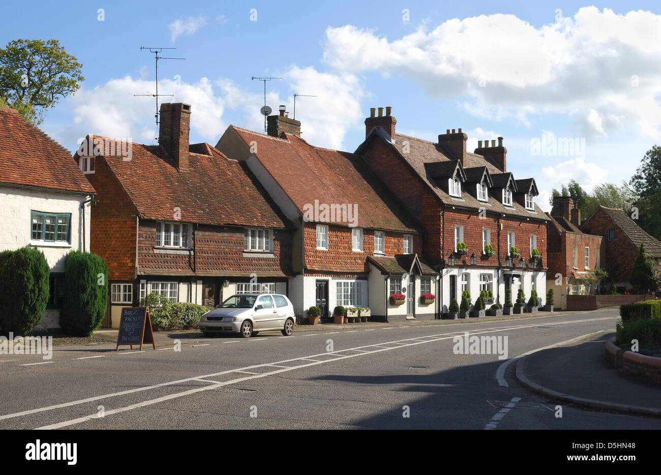 Tiled and brick cottages on main road at Chiddingfold. Surrey. England