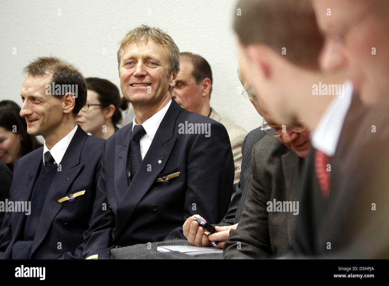 The chairmen of pilots' union 'Pilotenvereinigung Cockpit' (VC) Joerg Cebulla (L) and Winfried Streicher (2-L) attend a court hearing at the Labour Court in Frankfurt Main, Germany, 22 February 2010. Lufthansa has handed in a fast track appeal against VC's strike claiming it was illegal. Some 4.000 Lufthansa pilots began their four-day-long strike at 00:00, forcing Luftansa to canc Stock Photo