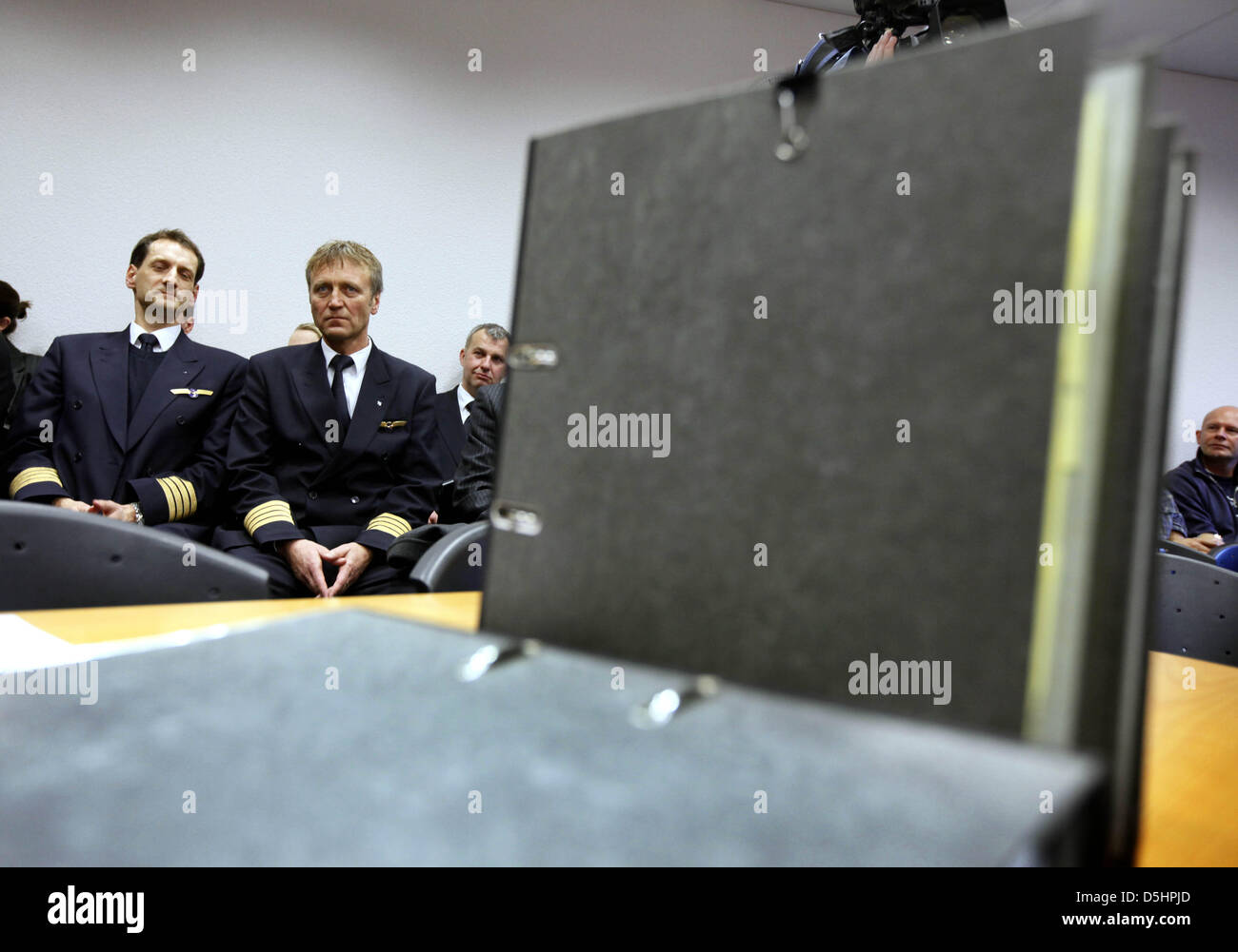 The chairmen of pilots' union 'Pilotenvereinigung Cockpit' (VC) Joerg Cebulla (L) and Winfried Streicher (2-L) attend a court hearing at the Labour Court in Frankfurt Main, Germany, 22 February 2010. Lufthansa has handed in a fast track appeal against VC's strike, claiming it was illegal. Some 4.000 Lufthansa pilots began their four-day-long strike at 00:00, forcing Luftansa to can Stock Photo