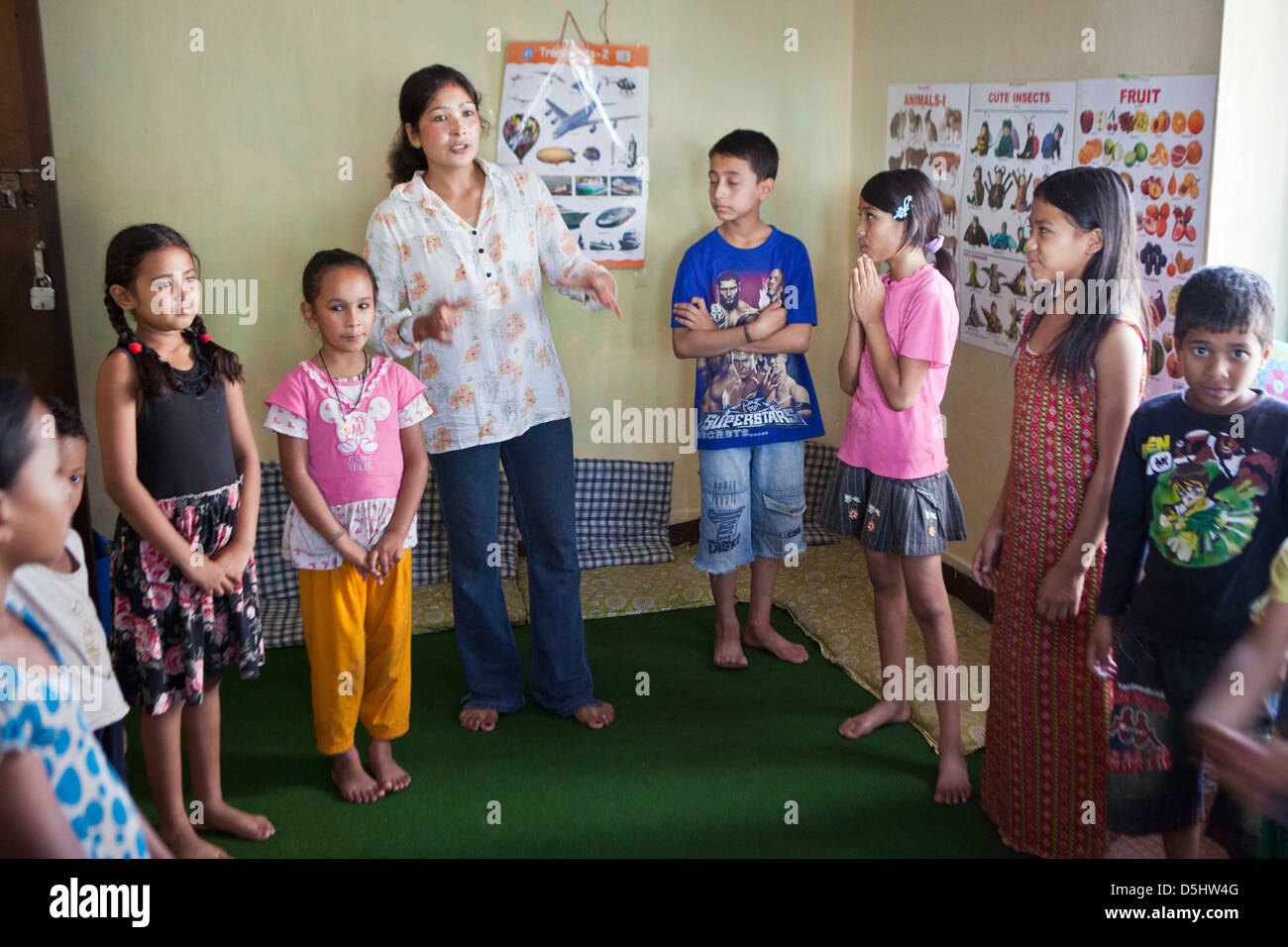 Staff leads a play session with young street-children at Voice for Children rehabilitation center in Kathmandu, Nepal. Stock Photo