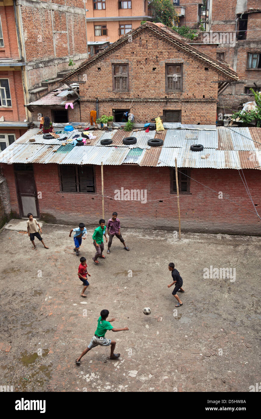 Nepalese street children play football at Voice of Children rehabilitation center, Kathmandu, Nepal. For kids at risk of abuse. Stock Photo