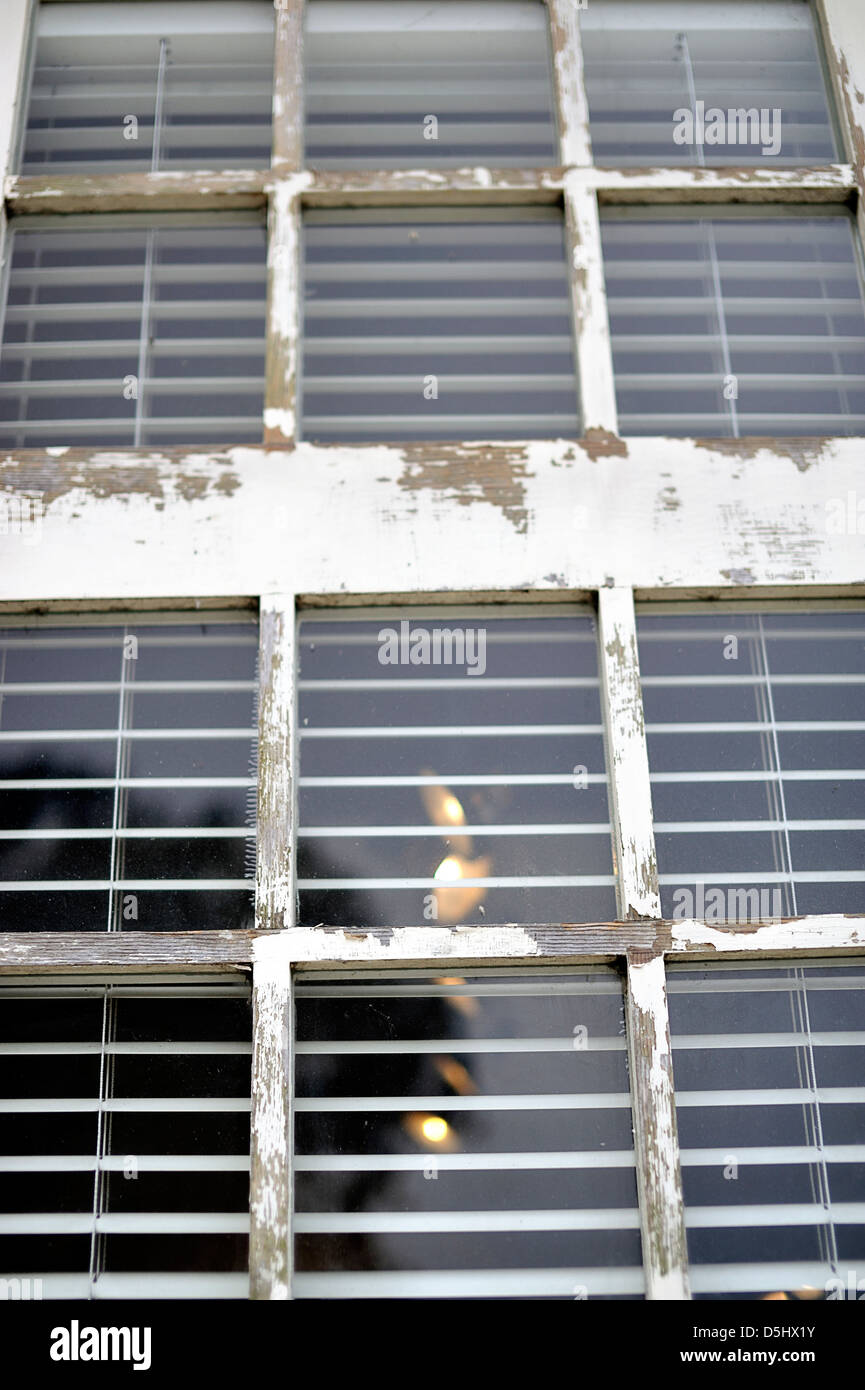 Exterior of glass window with peeling paint on frame Stock Photo - Alamy