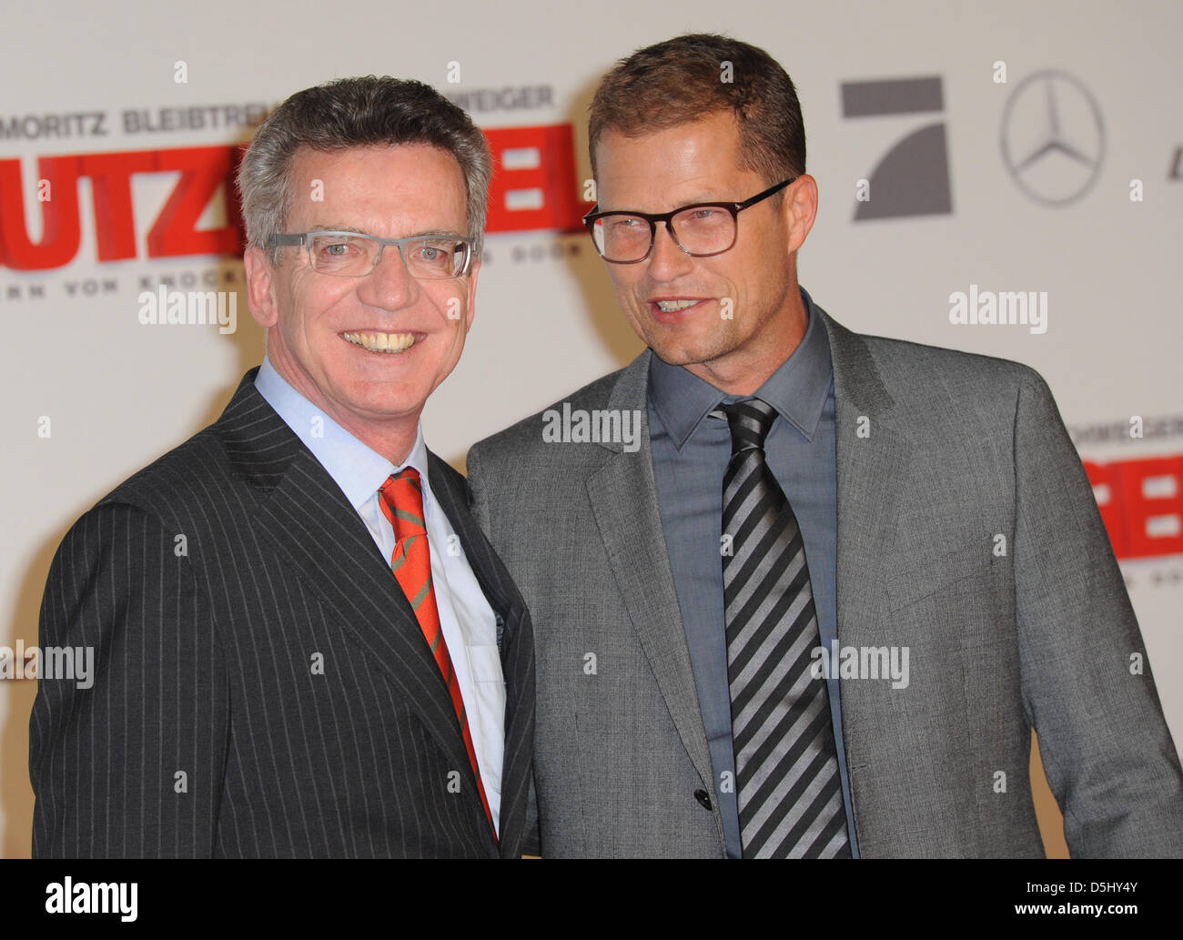 German Minister of Defence Thomas de Maiziere  (CDU, L) and actor Til Schweiger pose on the red carpet at the premiere of the movie 'Guardian Angel' (Schutzengel) in Berlin, Germany, 18 September 2012. The movie will start showing in German cinemas on 27 September 2012. Photo: Britta Pedersen Stock Photo