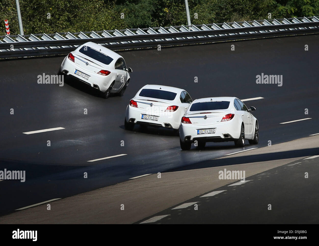 Three Opel Insignia OPC race along the racecourse at the new Opel testing center in Rodgau-Dudenhofen, Germany, 20 September 2012. Ailing car manufacturer Opel has invested 28.5 million euro in expanding and improving its testing center near its parent plant in Ruesselsheim. Photo: FRANK RUMPENHORST Stock Photo