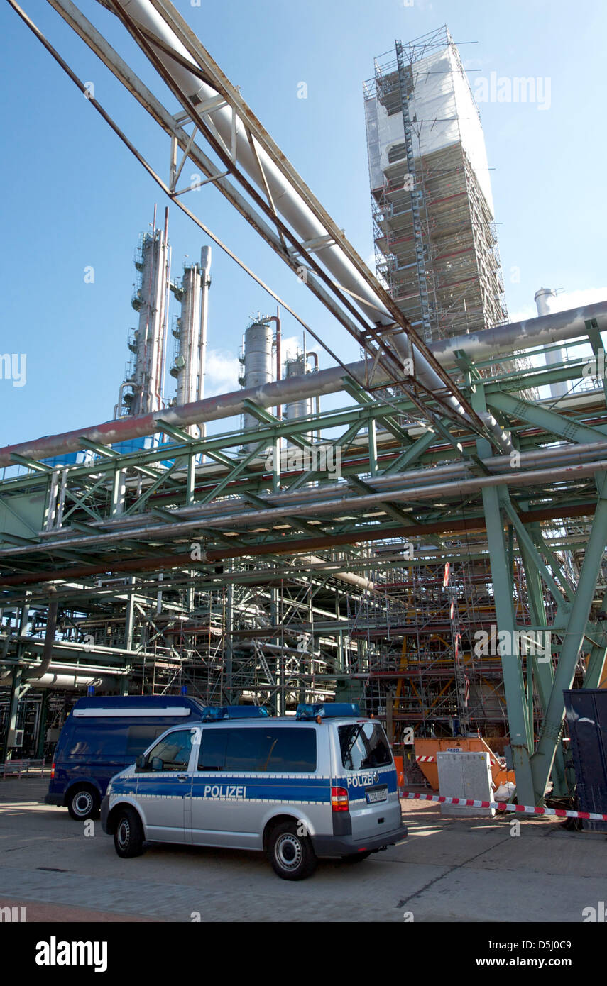 Policemen gather at the foot of the flare of the ammonia plant of SKW
