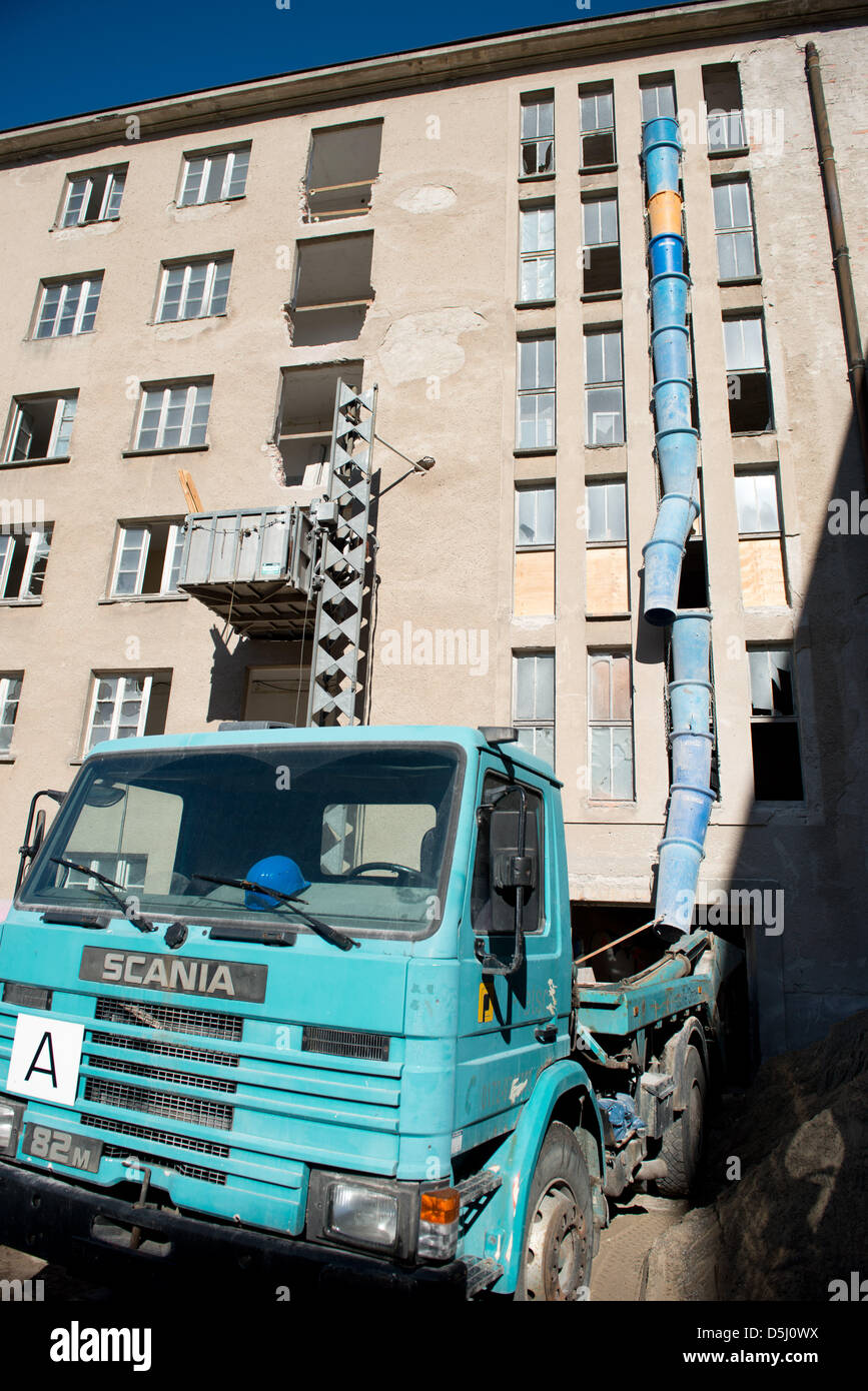 A construction vehicle is parked in front of buildings of Block II of the 'Strength Through Joy' sea spa Prora complex in Binz on Ruegen, Germany, 20 September 2012. Six years after the German state sold the former Nazi property , which the National Socialists planned as a seaside resort, to private investers renovations have begun to turn the buidlings into holiday apartments and  Stock Photo