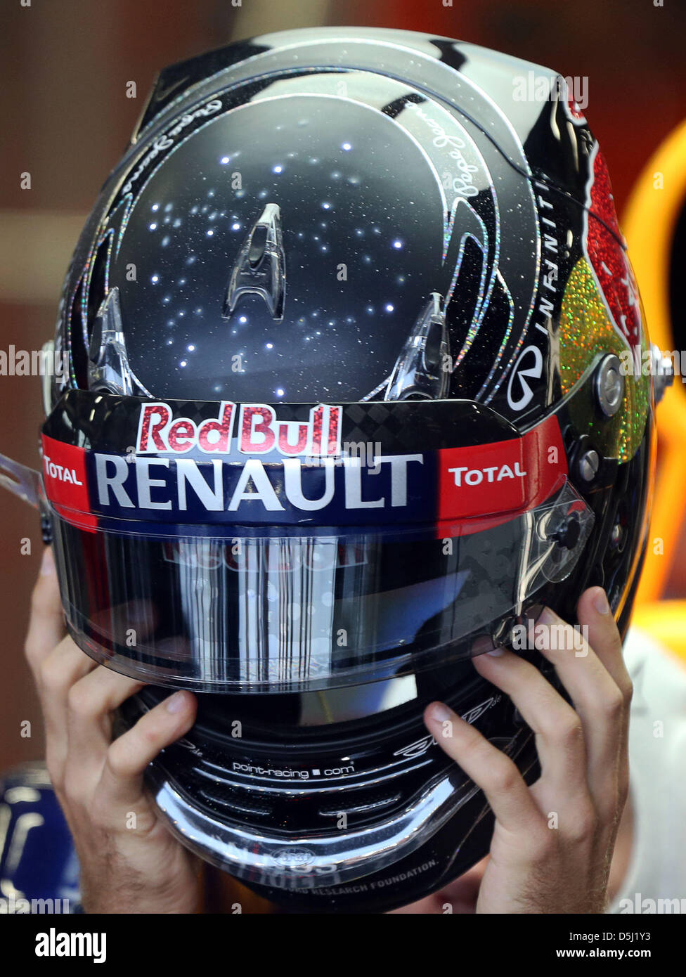 German Formula One driver Sebastian Vettel of Bull wears a special helmet displaying illuminated stars during the third practice session at the race track Marina-Bay-Street-Circuit, 22 September 2012. The Formula
