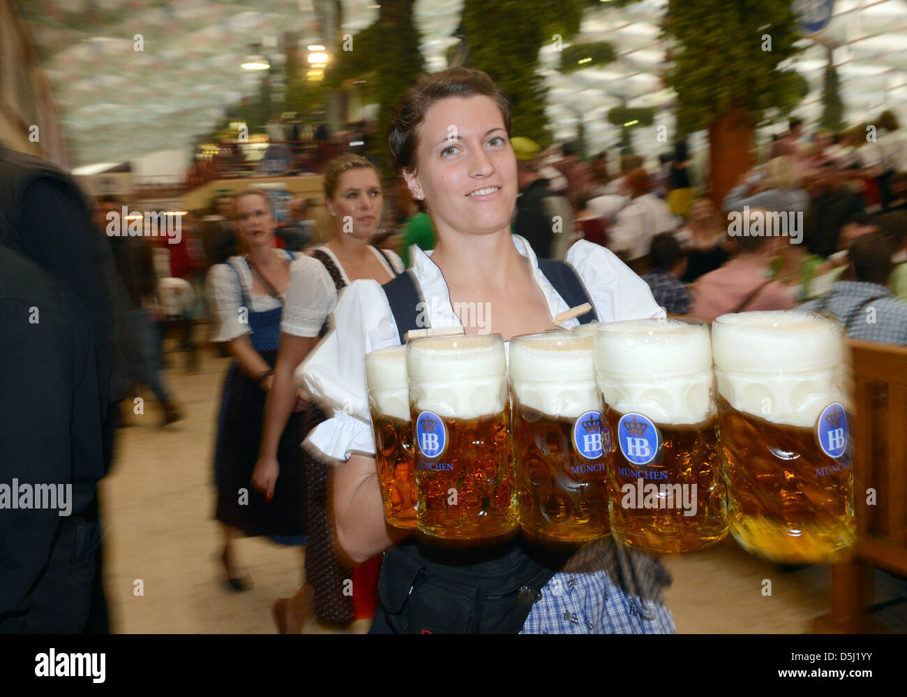 A waitress carries the first beer in the Hofbraeu tent during the ...