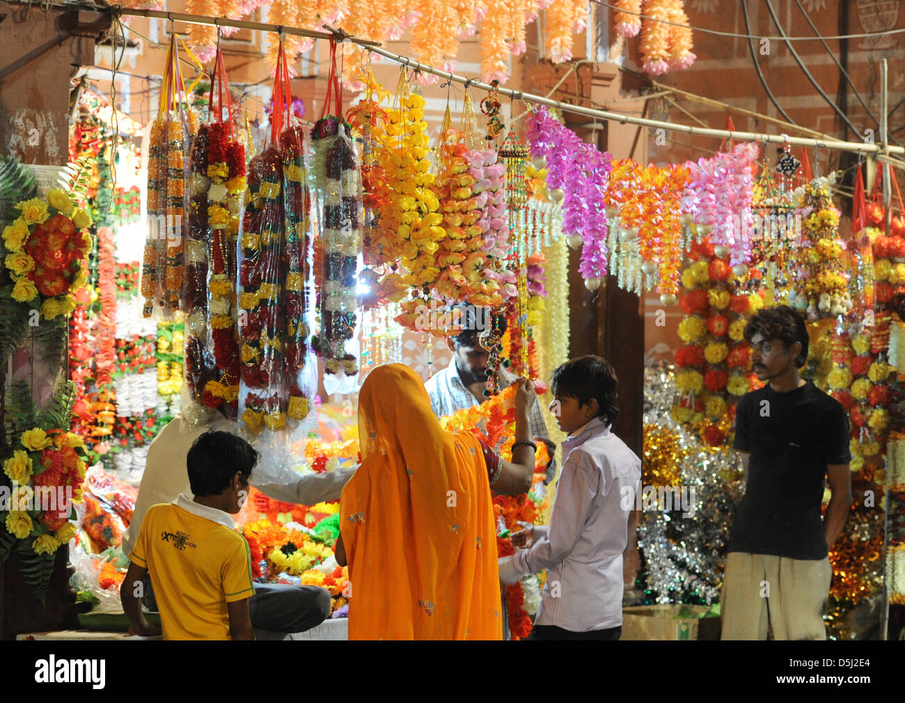 Flower girlands are sold on the street prior to the hindu celebration of Divalia in Jaipur, Germany, 12 November 2012. The festival of lights will last several days and involve fireworks. Families get together and cook. Before, they buy new clothes, jewellery and cooking gear. Photo: JENS KALAENE Stock Photo