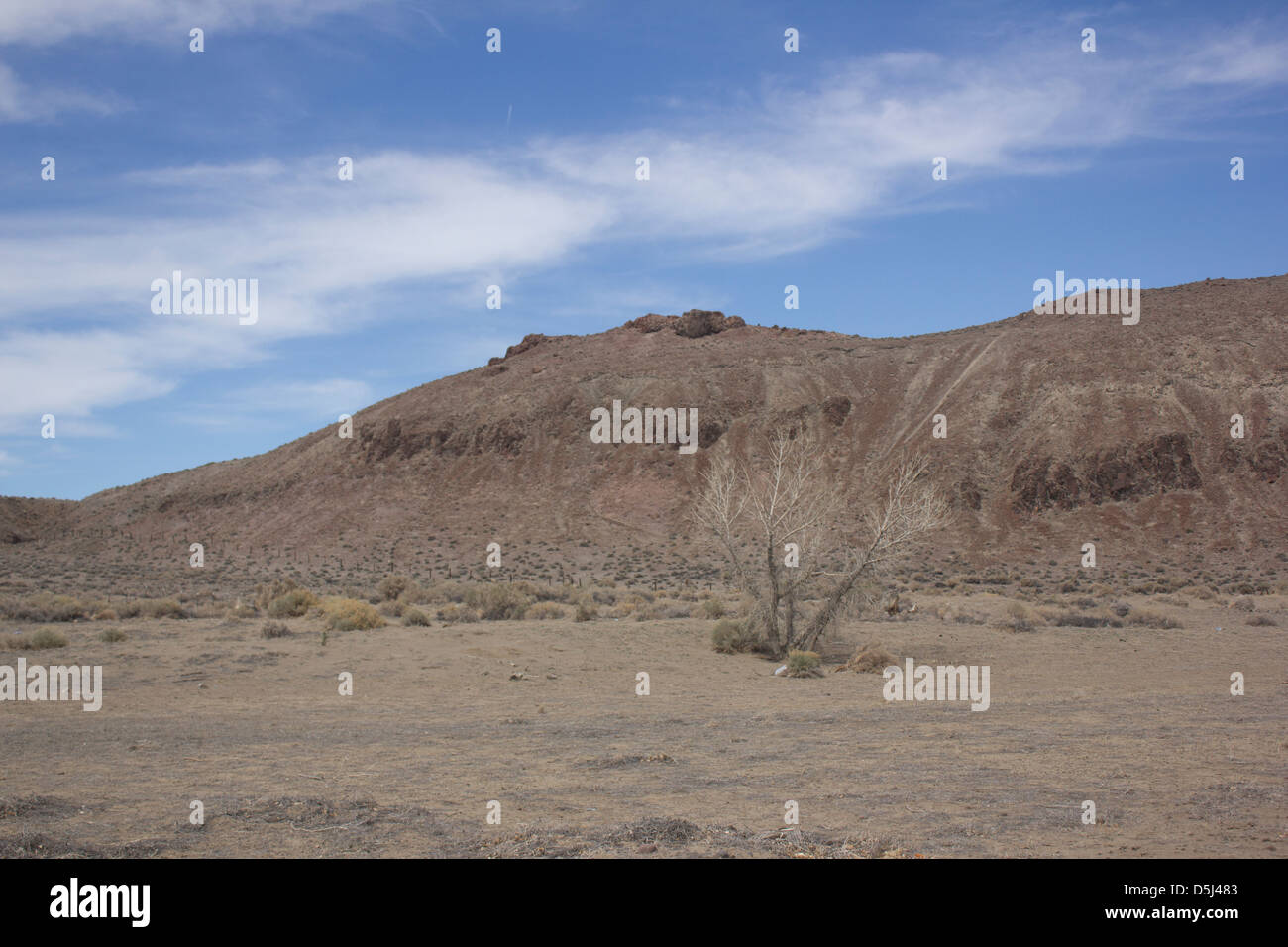 Desert mountain with blue skies and random clouds Stock Photo - Alamy