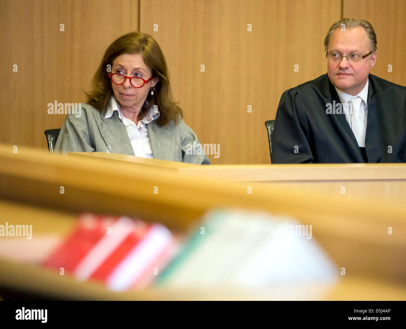 The plaintiff sits next to her lawyer Joachim gaertner before the announcement of the verdict in a acourt room of the German Fedral Labour Court in Leipzig, Germany, 14 November 2012. The Federal Labour Court ruled that employess have to hand in a medical certificate on the first day of their sick leave, if the empoyer so demands. Photo: Michael Reichel Stock Photo