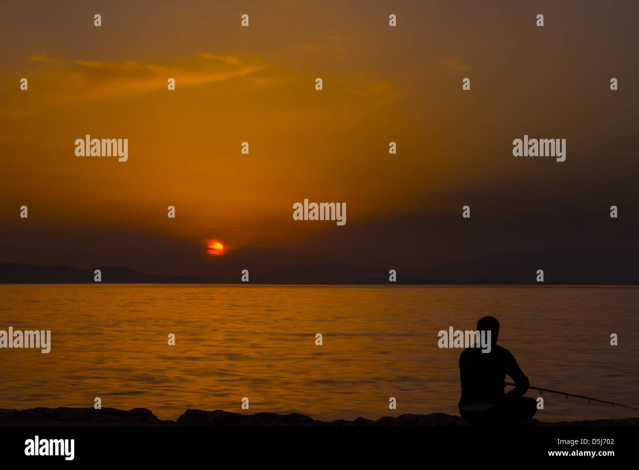 Fishing during the sundown Stock Photo - Alamy