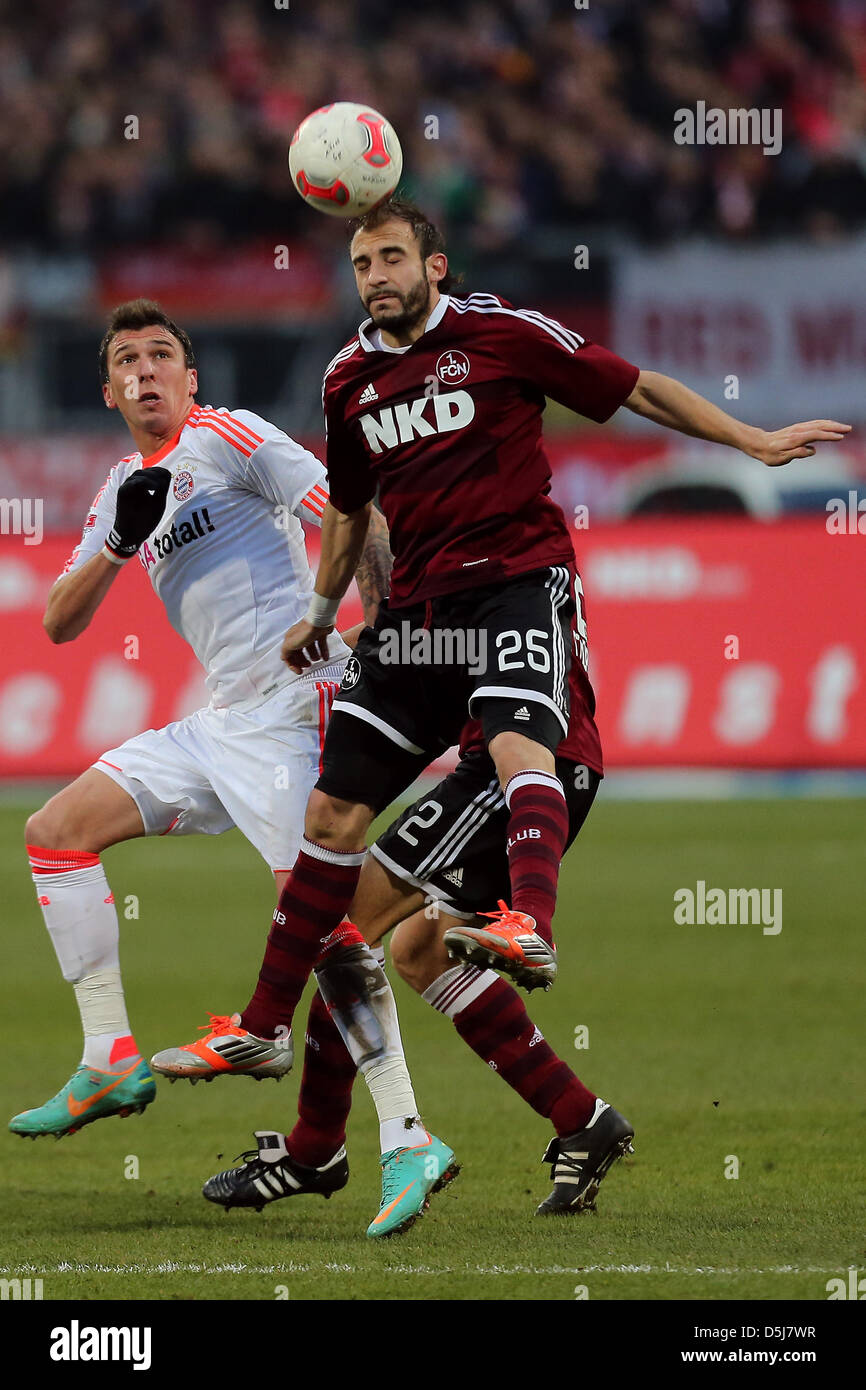 Nuremberg's Javier Pinola (R) and Munich's Mario Mandzukic vie for the ball during the Bundesliga soccer match between FC Nuremberg and Bayern Munich at Stadium Nuremberg in Nuremberg, Germany, 17 November 2012. Photo: ANDREAS GEBERT  (ATTENTION: EMBARGO CONDITIONS! The DFL permits the further  utilisation of up to 15 pictures only (no sequntial pictures or video-similar series of  Stock Photo