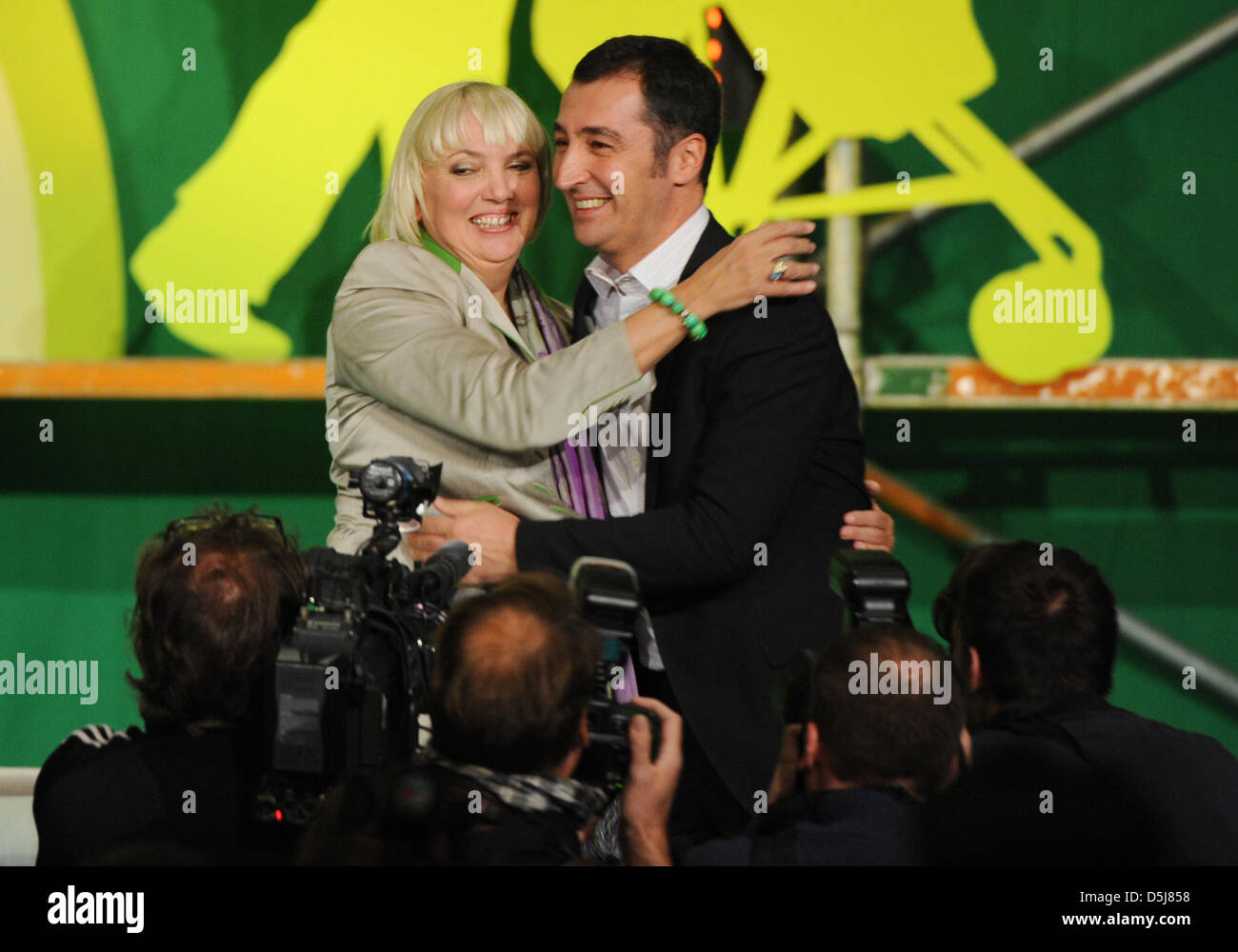 The federal heads of the Green Party, Claudia Roth and Cem Oezdemir (r), cheer after hearing the election results at the 34th delegate conference at Eilenriedehalle in Hanover, Germany, 17 November 2012. Photo: Emily Wabitsch Stock Photo
