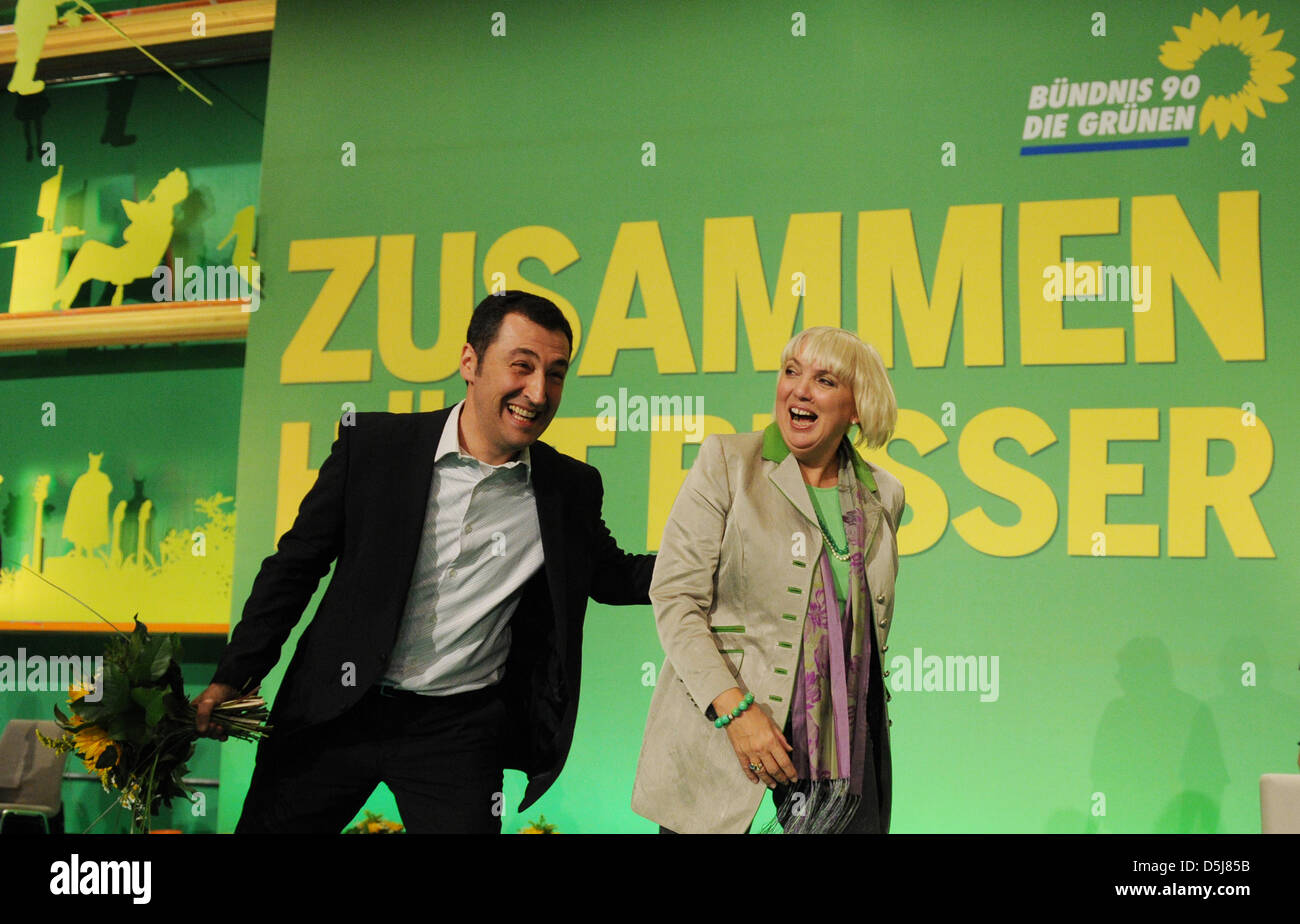 The federal heads of the Green Party, Claudia Roth and Cem Oezdemir (l), cheer after hearing the election results at the 34th delegate conference at Eilenriedehalle in Hanover, Germany, 17 November 2012. Photo: Jochen Luebke Stock Photo