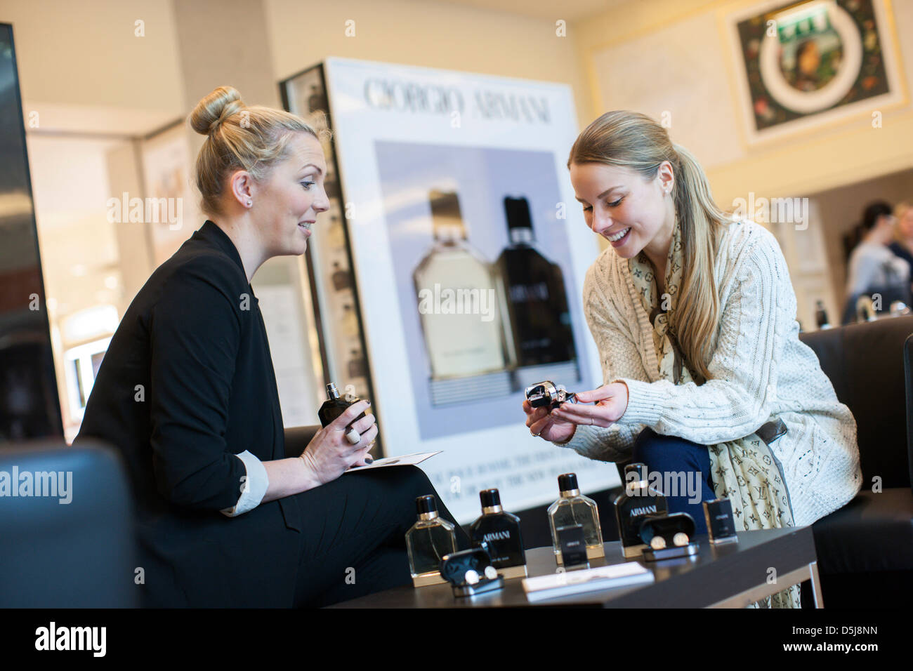 A young woman tries the new Giorgio Armani fragrance products