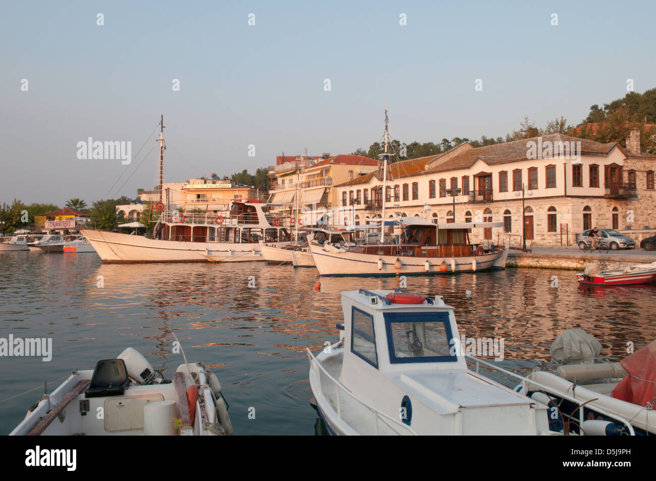 Greek island September The old harbour at Limenas Thassos Town Boats moored Waterfront houses Sunset Stock Photo