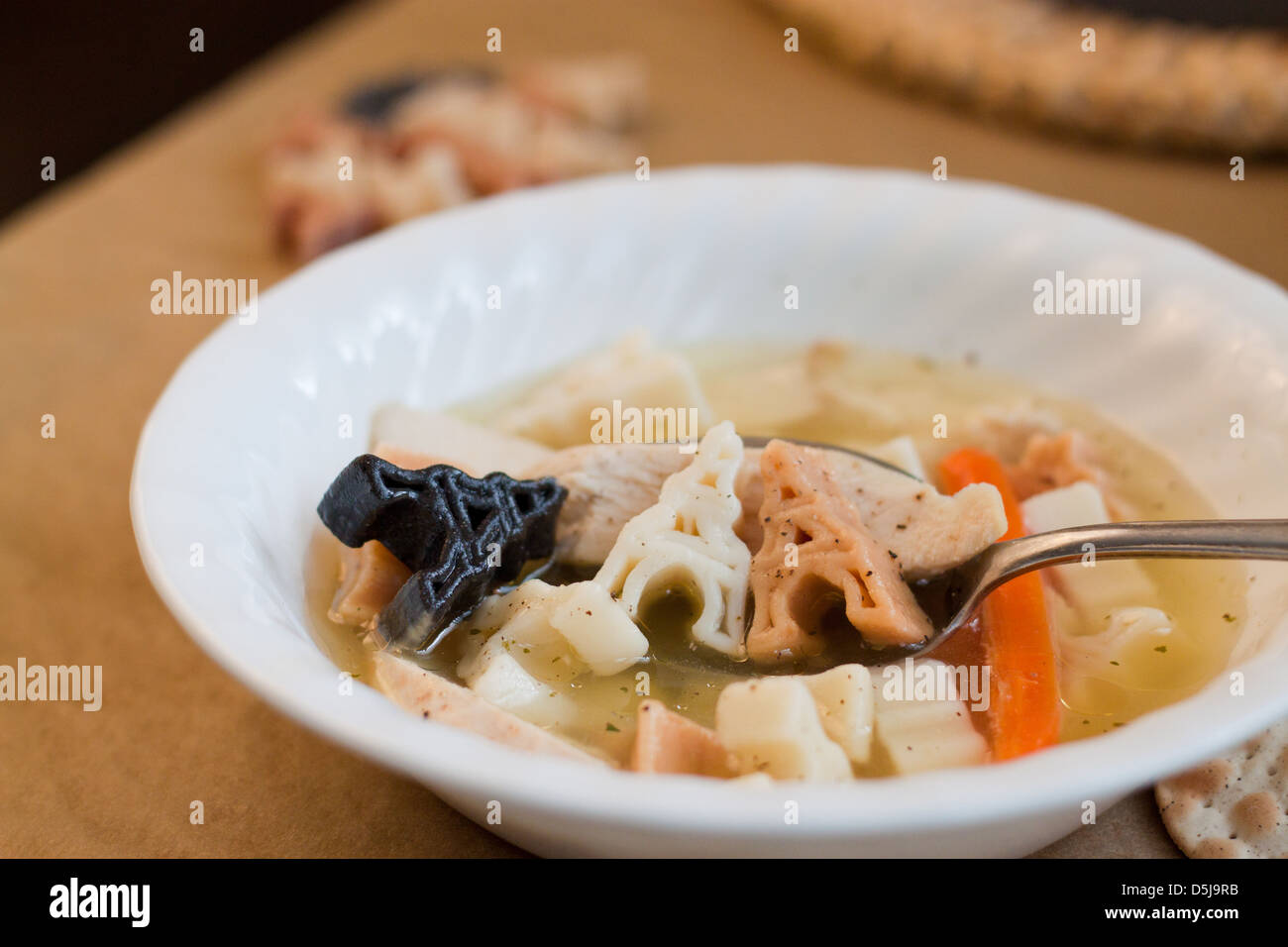 Chicken soup with Eiffel Tower noodles. Stock Photo