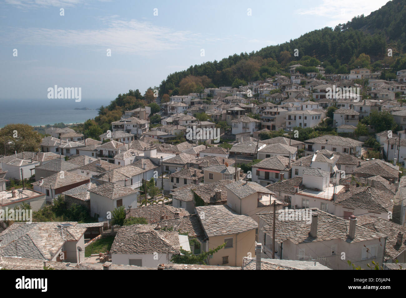Greek island September Grey slate roofs on the old houses in the mountain village of Panagia View east to the sea Stock Photo