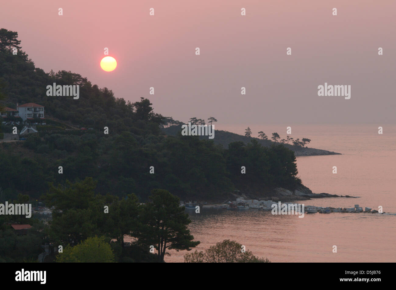 View from Golden beach Chrisi Ammoudia or Skala Panagias eastward to dawn sunrise Stock Photo