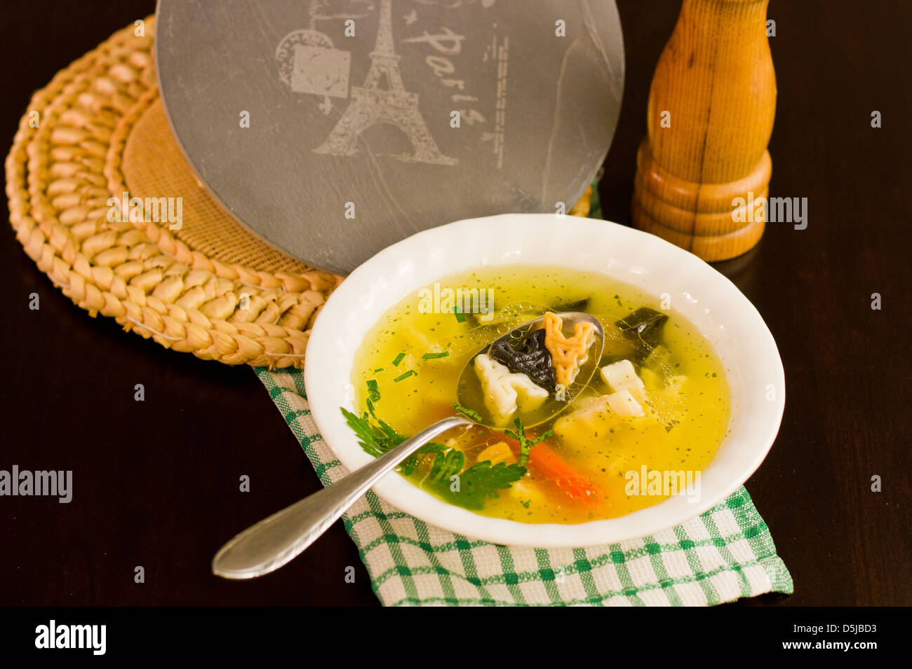 Chicken soup with Eiffel Tower noodles. Stock Photo