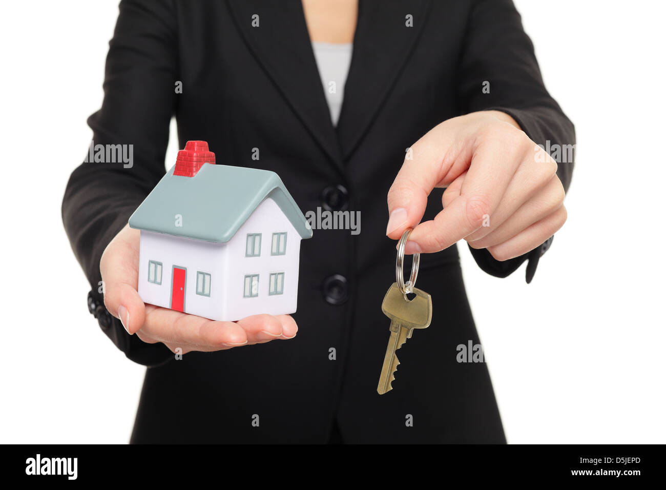 Business woman in suit holding new house keys and mini house model ...